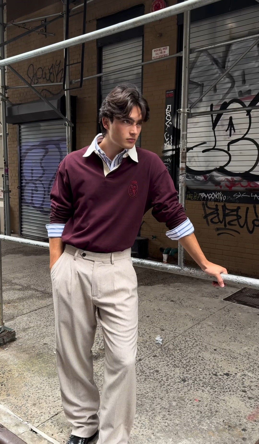 A guy wearing khaki pants and a casual shirt