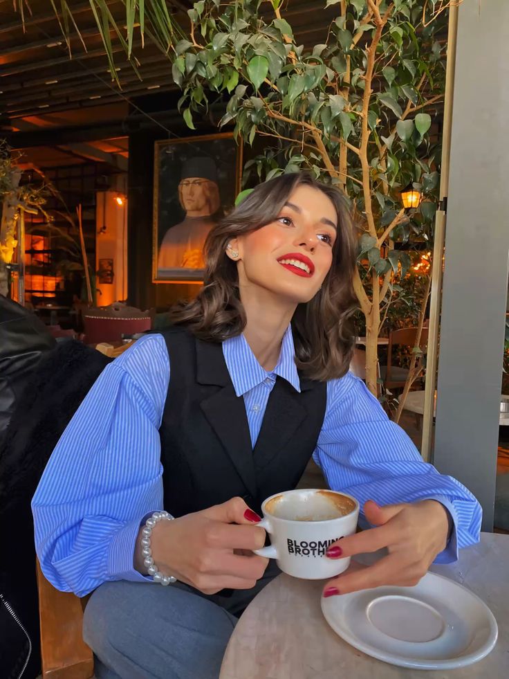 A girl wearing red lipstick at a coffee shop