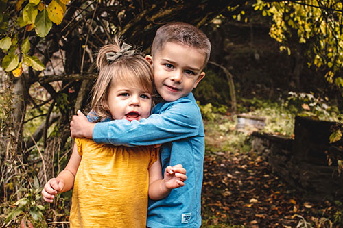 Brother and sister hugging