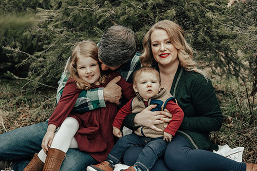 Family in Christmas Tree farm
