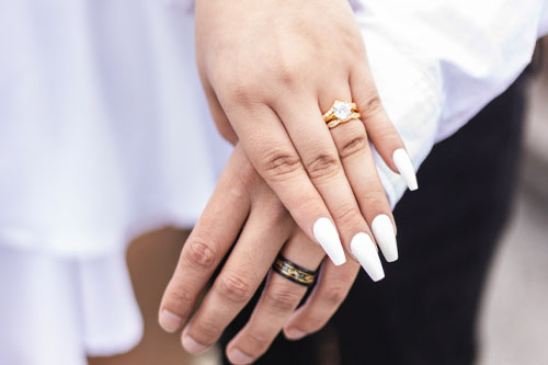 Couples hands with wedding rings