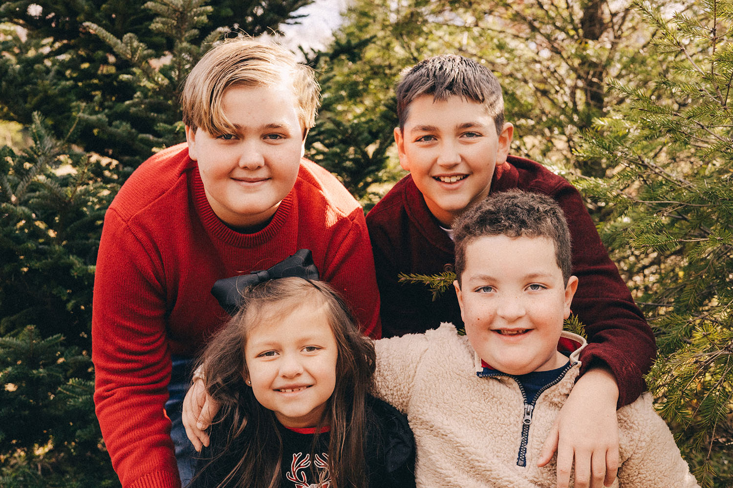 Four cousins with Christmas trees