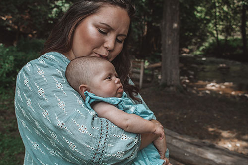 Mother with baby by creek