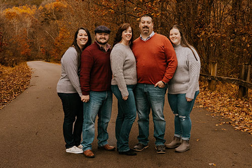 Family on road with fall color leaves