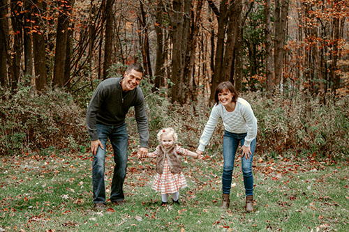 Parents holding hand with child