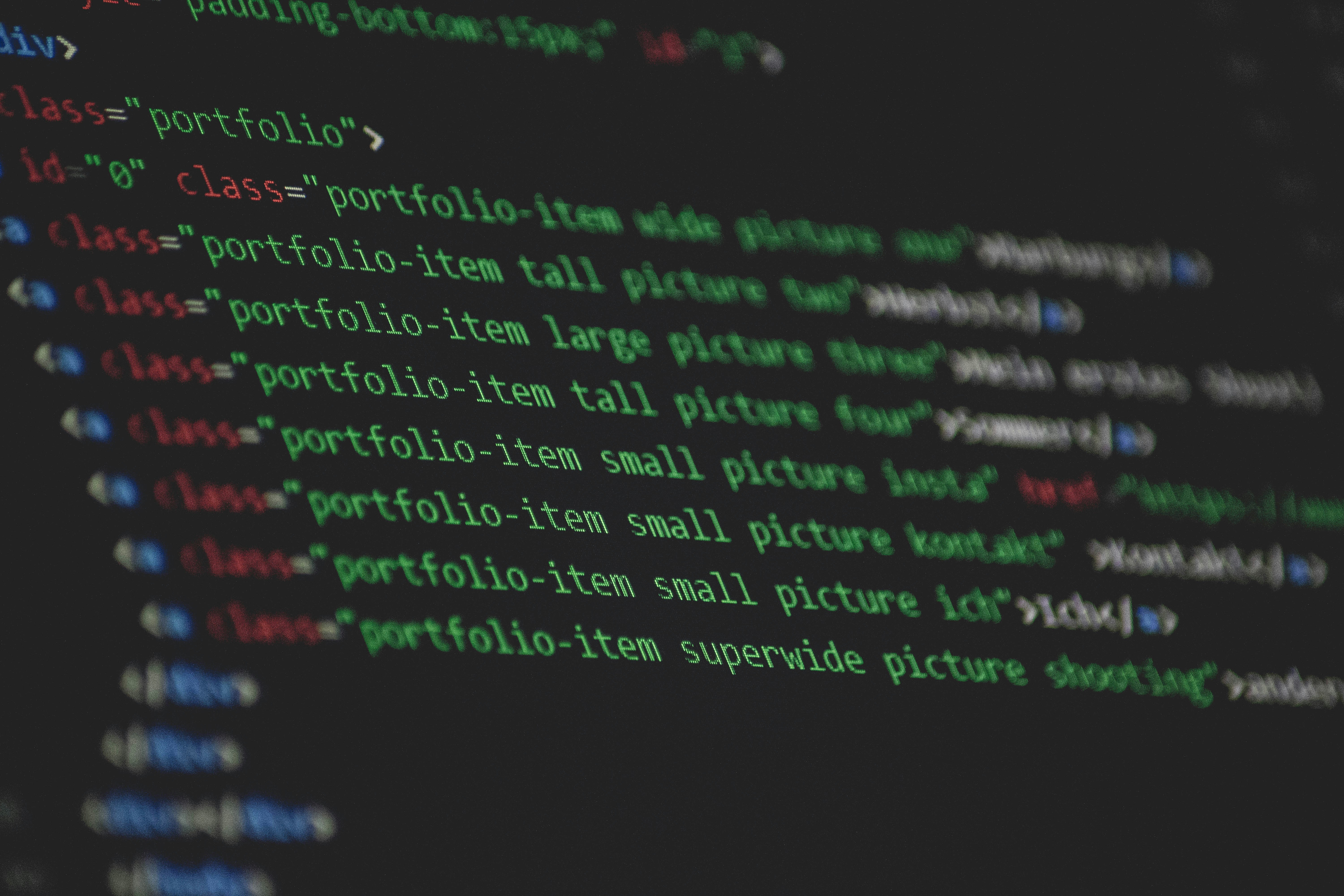 Image of a laptop screen showing code for a website